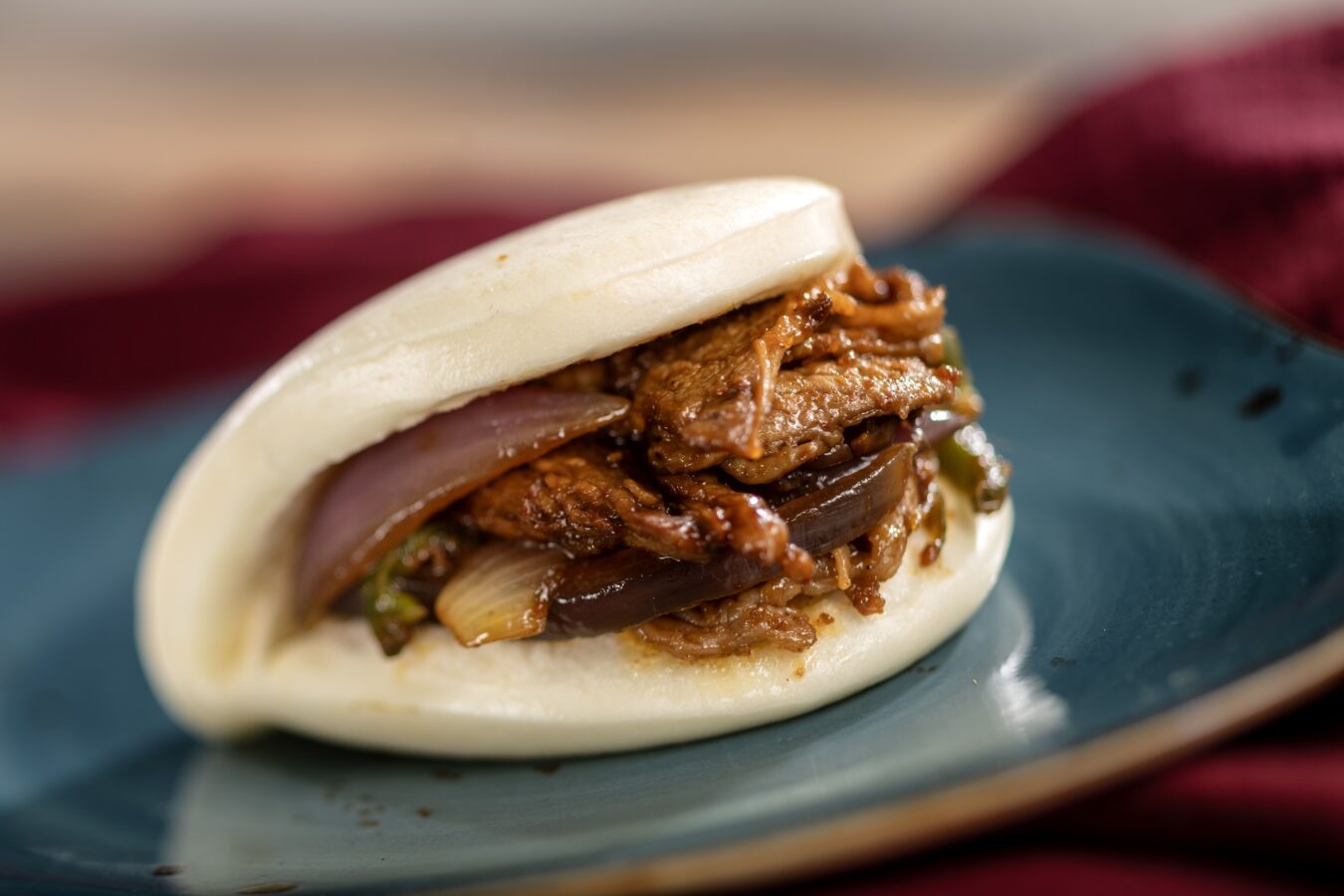 Sha Cha Beef Bao Bun Lan Yuan China A soft pillowy bun filled with pan fried beef red onion and jalapeño in a savory Chinese peanut sauce