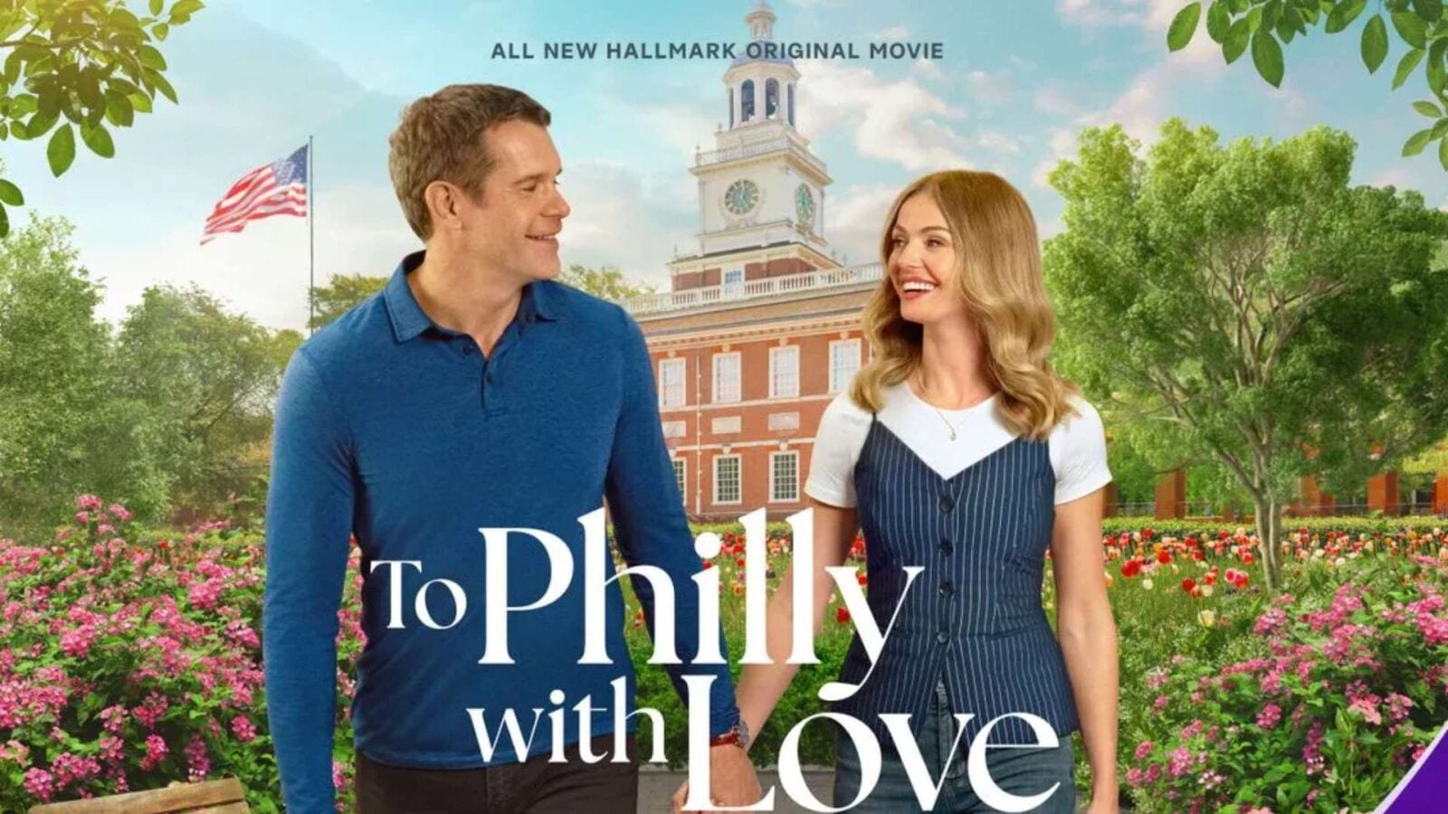 Promotional poster for Hallmark movie To Philly with Love showing a smiling couple walking through a flower filled garden with a red brick building in the background