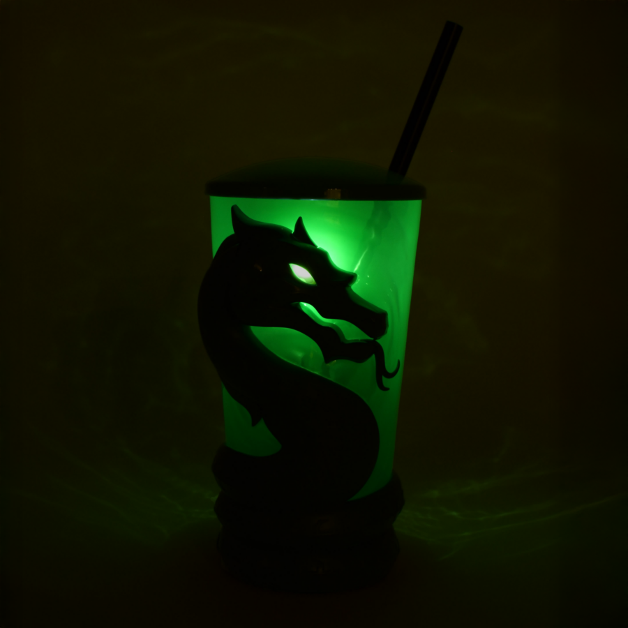Glowing green dragon themed tumbler with straw lit from inside in a dark background