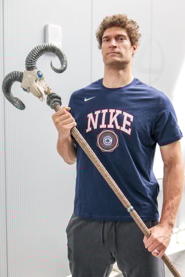 P1029706 Fantasy Land News Man in a blue Nike shirt posing with a fantasy staff topped by a ram skull and curved horns