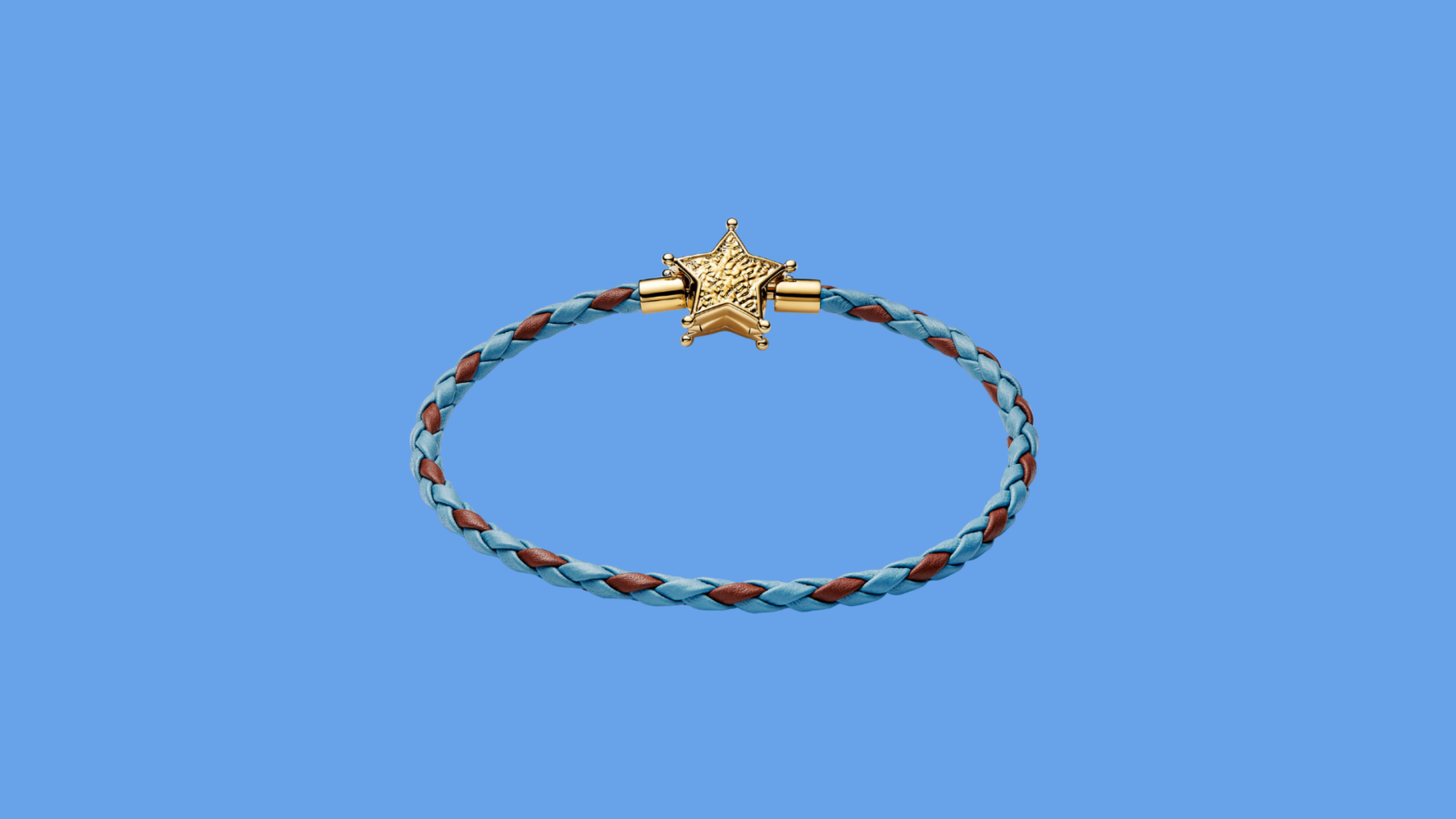 Blue braided bracelet with a gold star clasp against a blue background