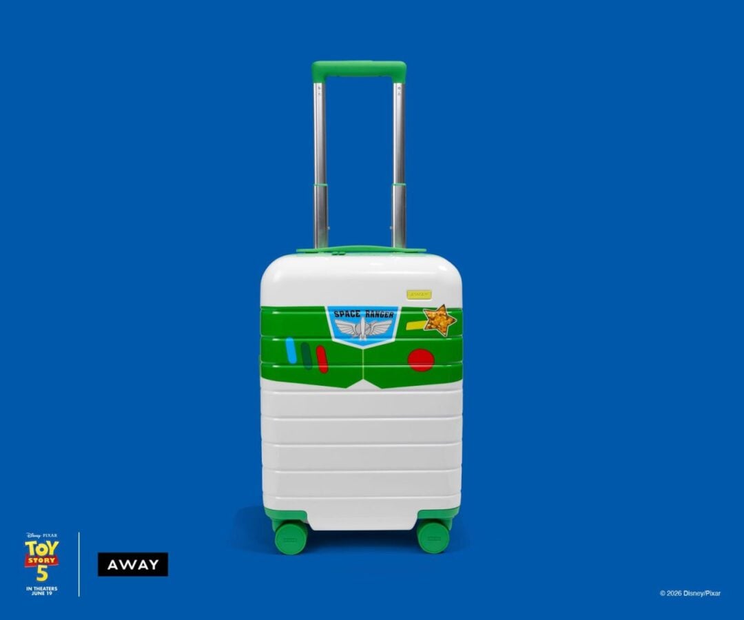 Luggage suitcase with Space Ranger design from Toy Story 5 on a blue background showing green accents and wheels with logos in bottom corners Away and Toy Story 5