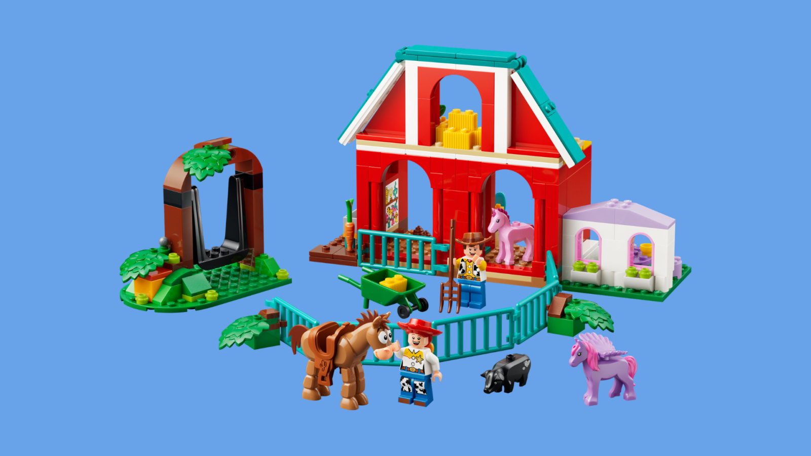 Colorful LEGO farm set with a red barn green fences and toy animals on a blue background
