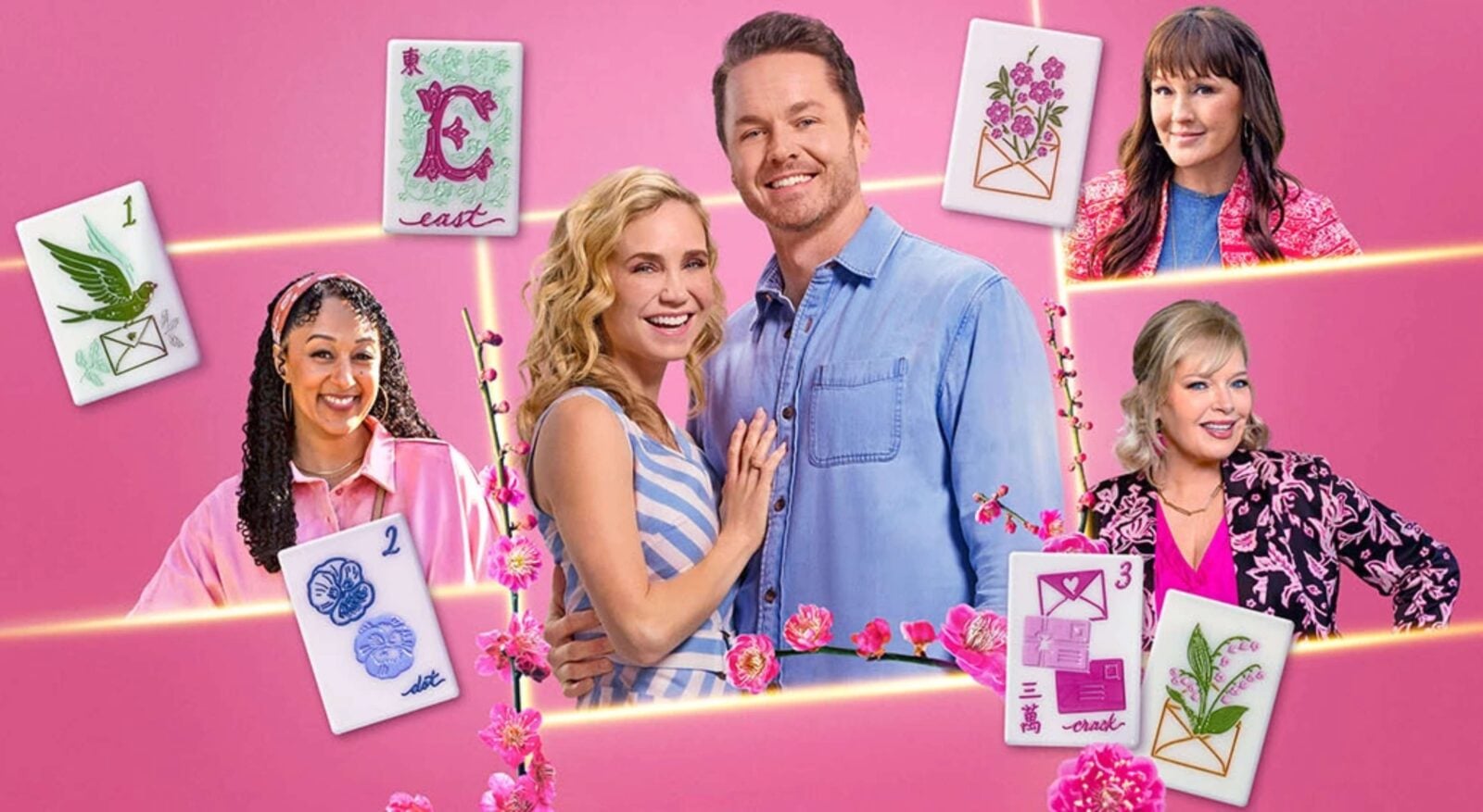 Five adults smiling and posing with illustrated cards against a pink background