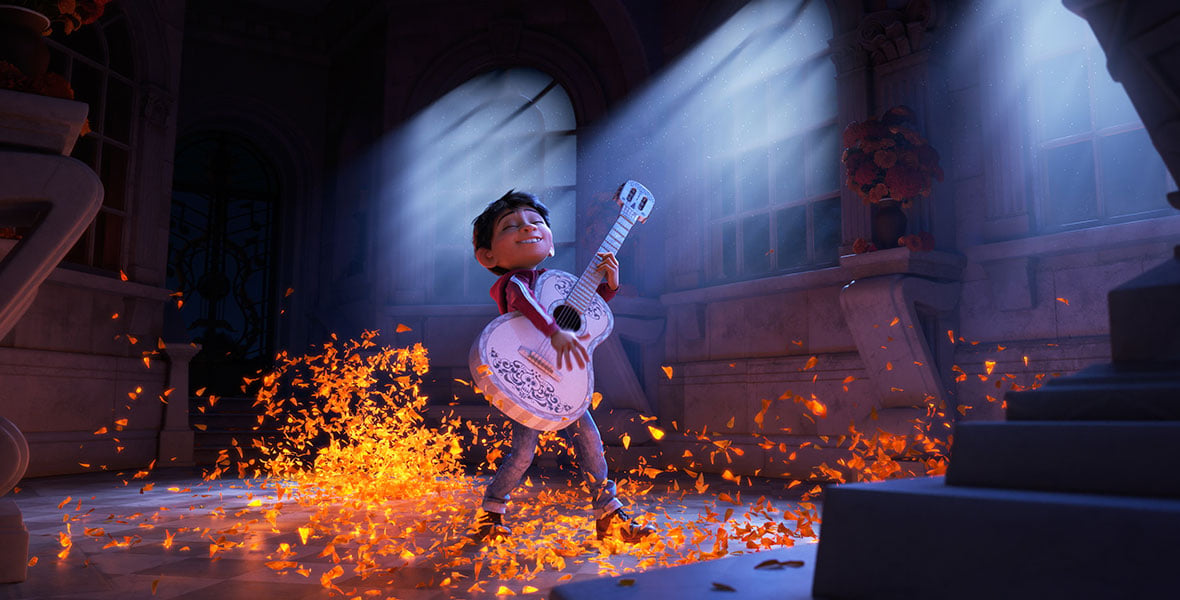 Young boy plays a guitar on a marble floor as glowing orange petalssparks swirl around him in a grand hall with blue light beams