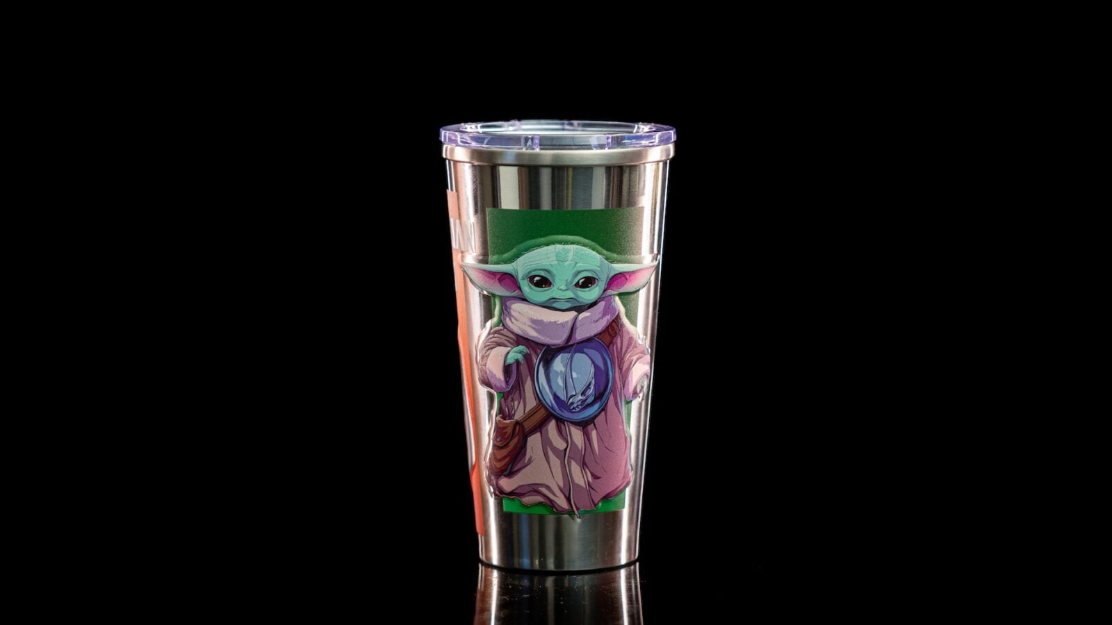Stainless steel tumbler with a Grogu Baby Yoda sticker on a black background and a translucent lid