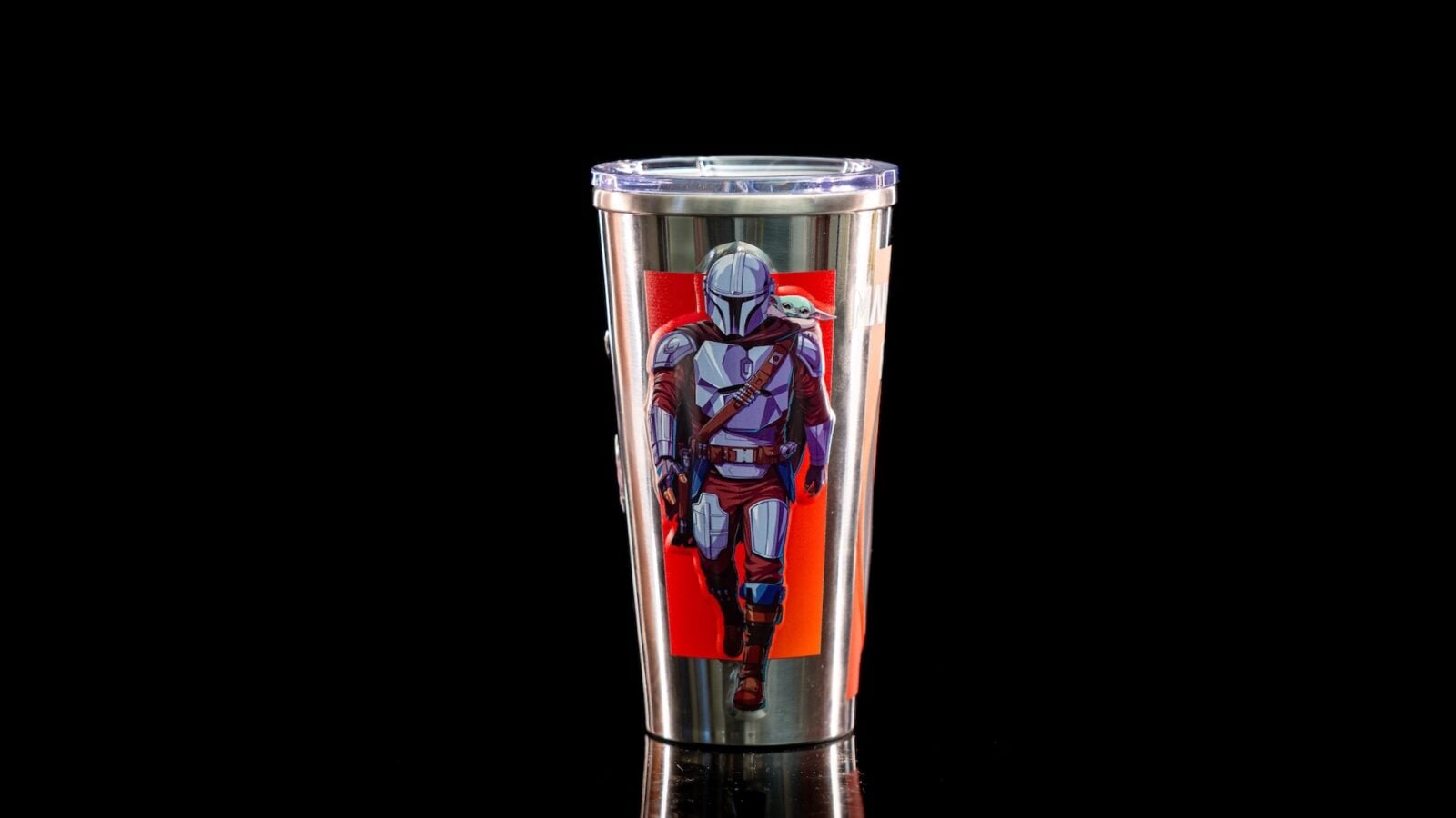 Stainless steel tumbler with a Mandalorian and Grogu illustration on a red panel against a black background