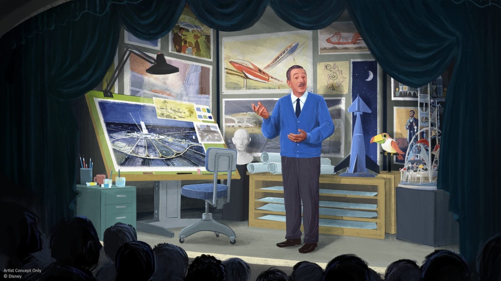 A man in a blue jacket gives a lecture in a gallery like studio filled with aerospace models posters and display cases with an audience watching