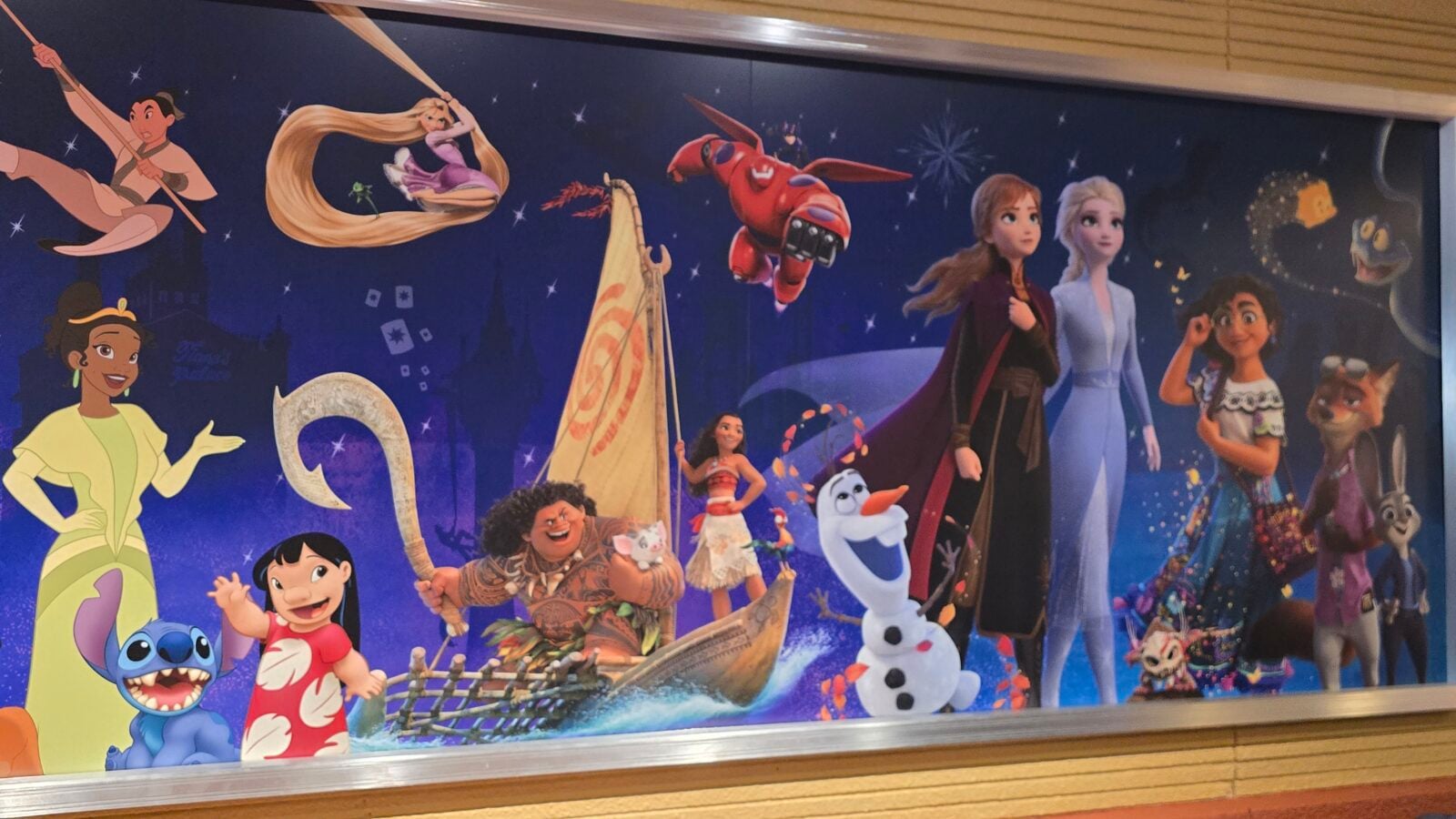 Group of DisneyPixar characters in a night sky mural posing and performing together Elsa Anna Rapunzel Moana Olaf Stitch etc