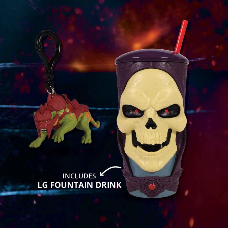 Skull shaped cup with a purple lid and red straw featuring a grinning yellow skull and a decorative base a red green dragon keychain hangs nearby Text reads Includes LG Fountain Drink