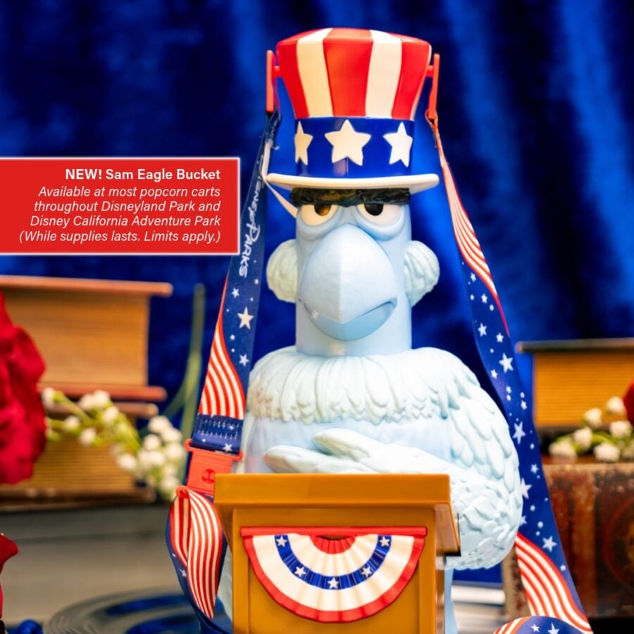 69834731913936881894725698105182955623670819n Fantasy Land News Patriotic blue eagle statue wearing an Uncle Sam hat at a podium with a red promotional sign reading NEW Sam Eagle Bucket and star spangled ribbons nearby