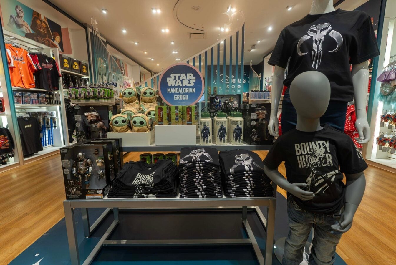 70512238817443815098738515777931734047720329n Fantasy Land News Star Wars shop display with Grogu plush toys Mandalorian sign and Bounty Hunter shirts on a mannequin