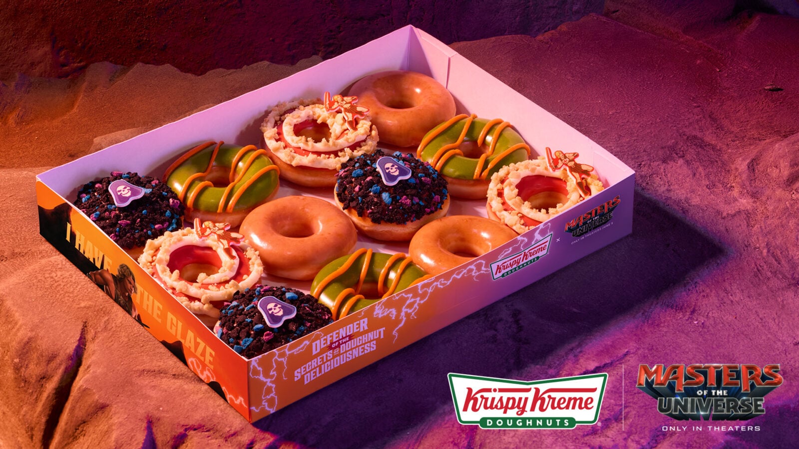 KKD x Masters of the Universe Media Image 1 Fantasy Land News Assorted Krispy Kreme donuts in a Masters of the Universe themed box with colorful icing sprinkles and cookie toppers