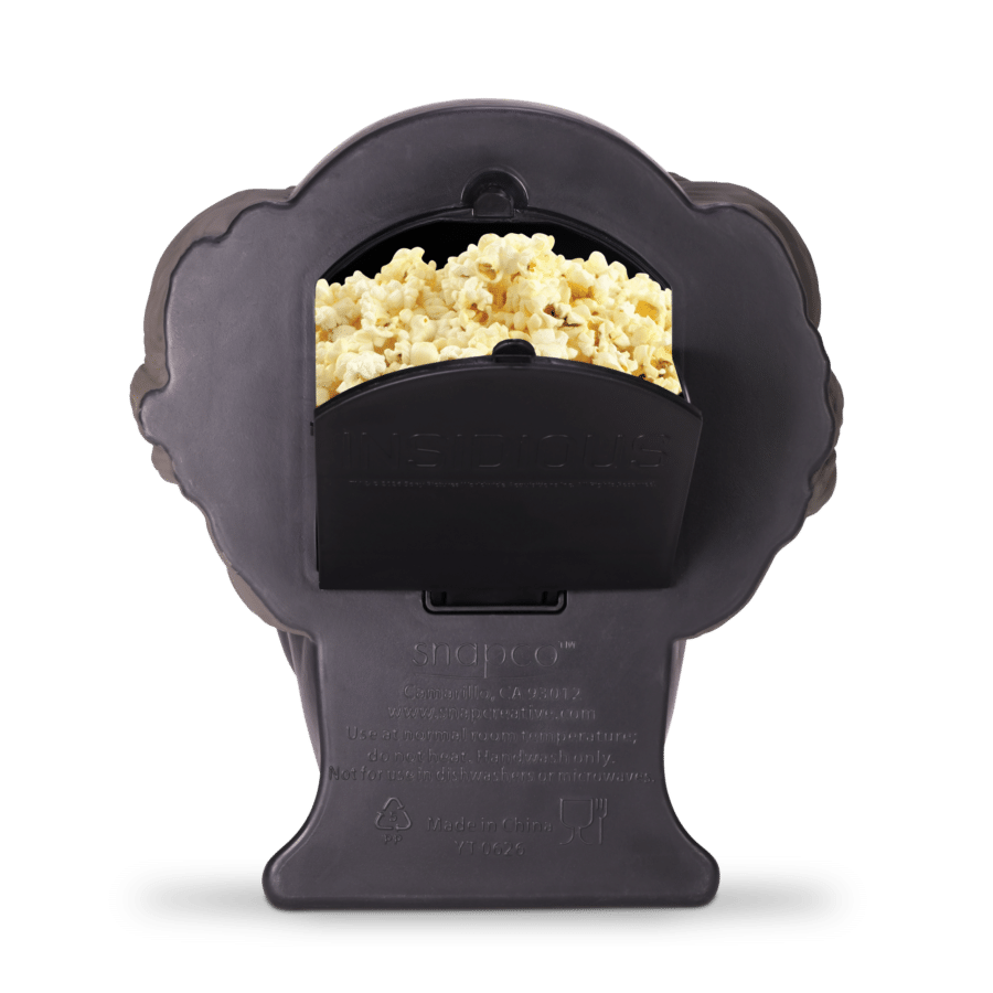 Dark gray popcorn maker with freshly popped popcorn visible in the front opening area