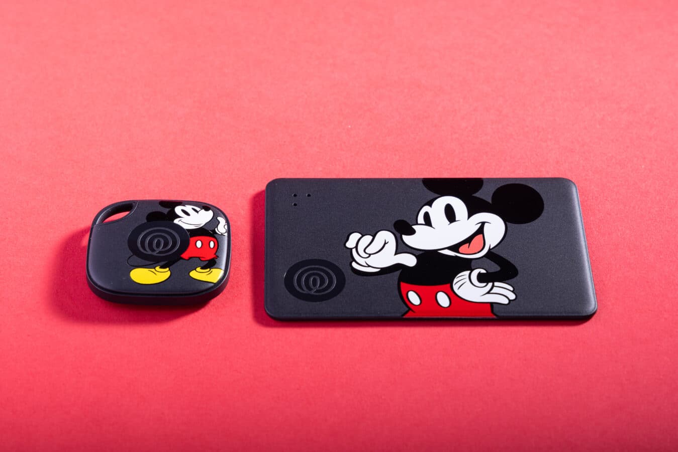 Black phone accessory and small case with Mickey Mouse artwork on a pink background