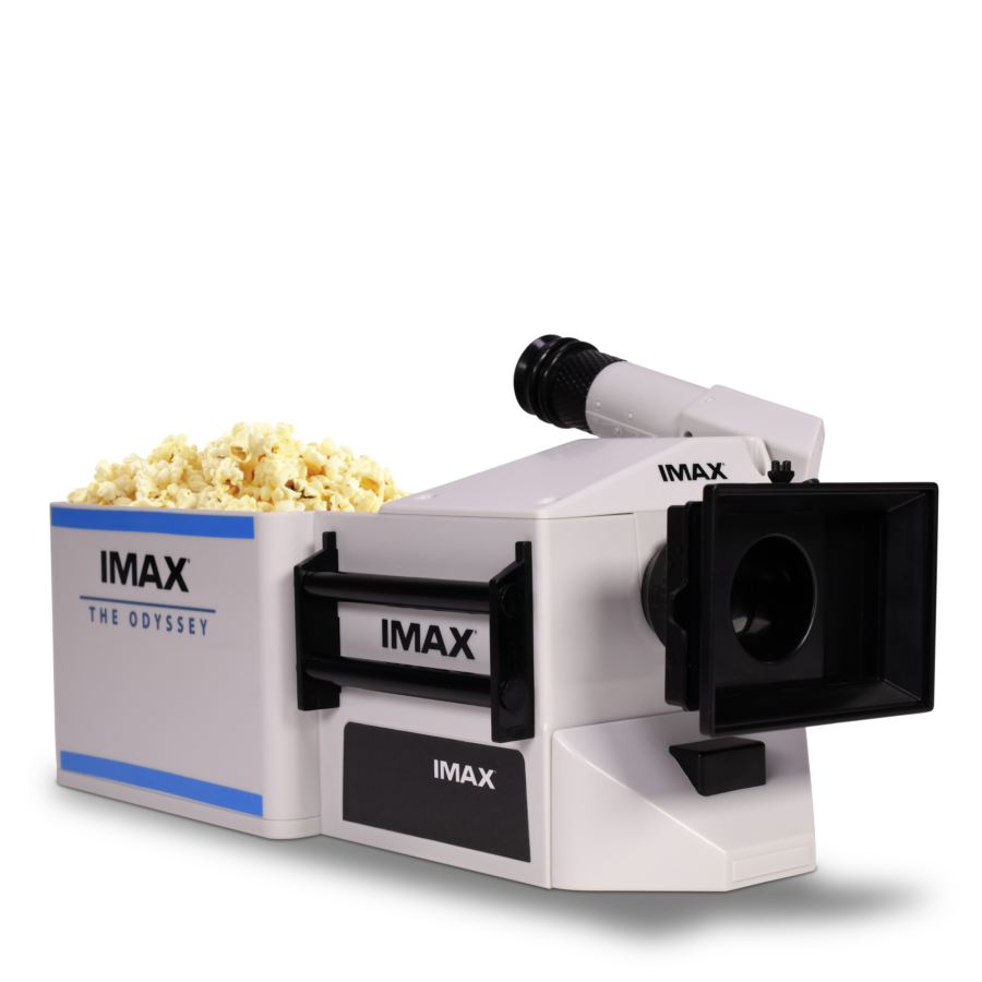 IMAX popcorn machine with a large pile of popcorn in front and the white body visible