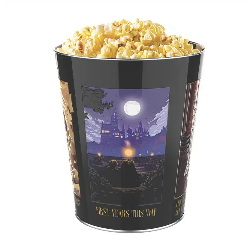 P9FWhGbg Fantasy Land News Popcorn filled black tin bucket with a moonlit castle artwork and the caption First years this way on the label