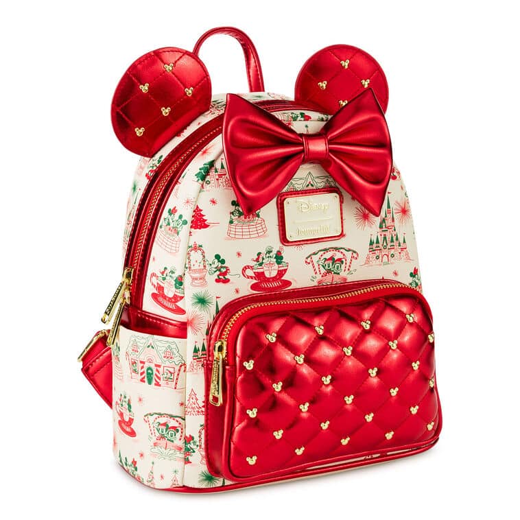 Christmas themed mini backpack in red and ivory with a quilted red front pocket gold zippers and tiny gold Mickey mouse heads features a large red bow and red ears shaped accents
