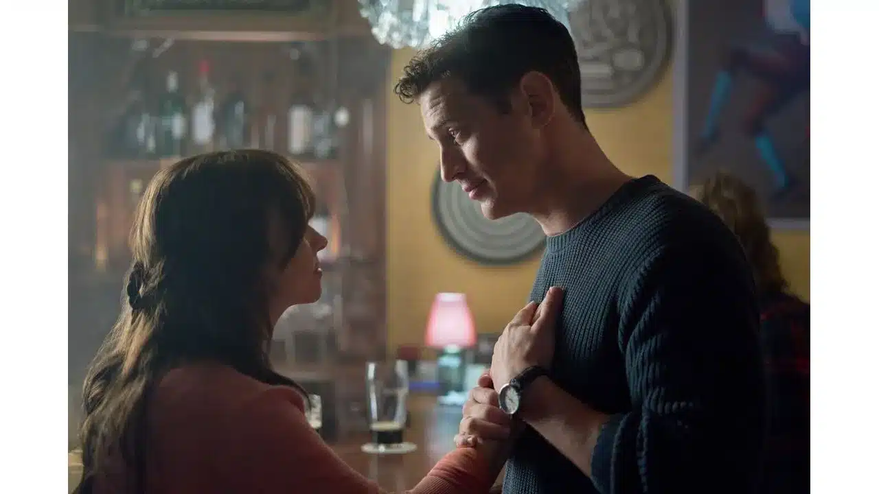 Say Oui To Romance in Paris Is Always a Good Idea on Hallmark+ Review2 Fantasy Land News A woman and man share a tender moment at a dim bar the woman holding the mans hands as they gaze at each other