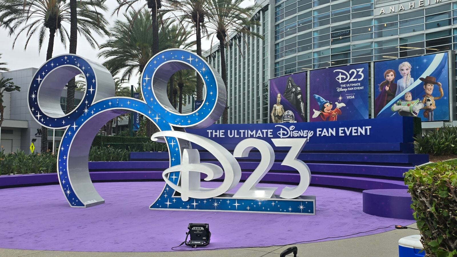 Large blue glittery infinity sculpture on a purple carpet at the Disney D23 fan event outside the convention center
