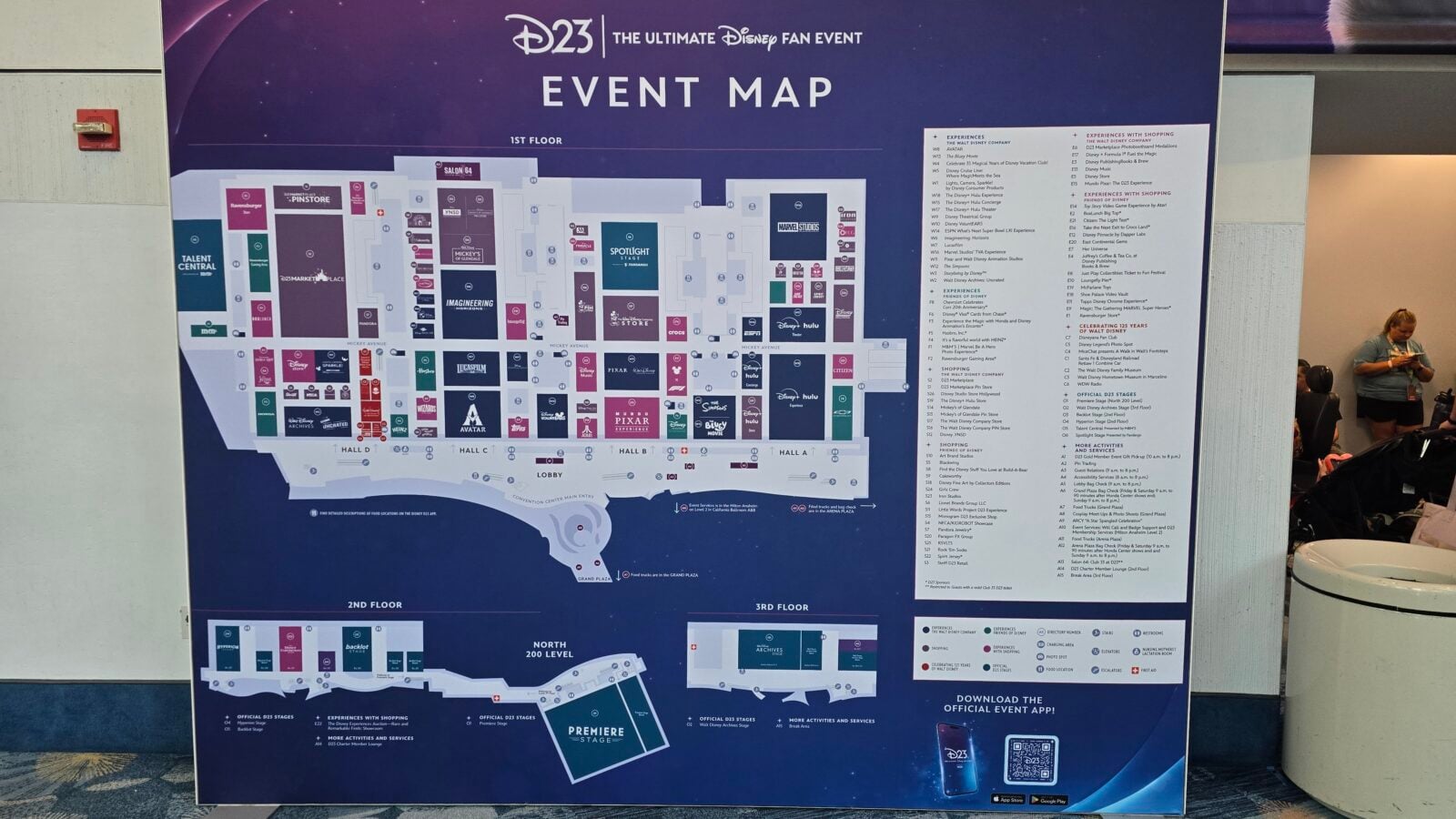 D23 Disney Ultimate Fan Event event map board showing a detailed floor plan on a purple background with booth logos and a right side directory panel
