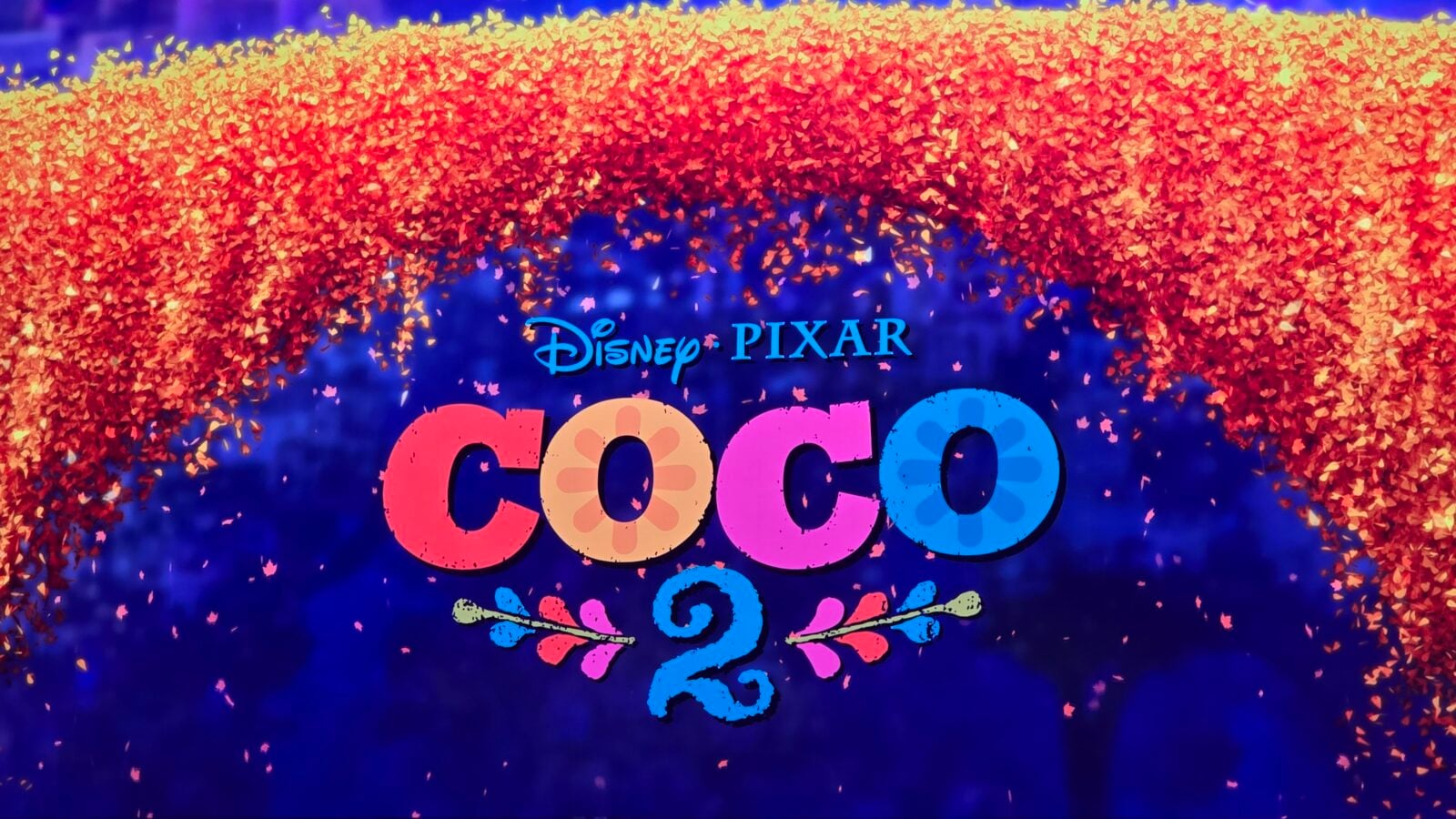 DisneyPixar Coco banner with colorful confetti arch and large multicolored COCO lettering below