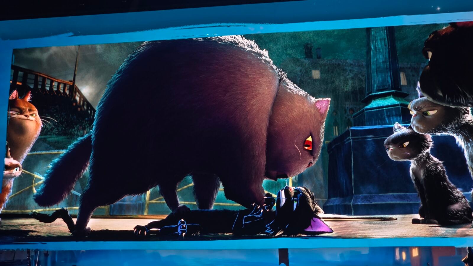 Large woolly mammoth and two small saber toothed cats inside a glass display blue framed exhibit animated movie scene
