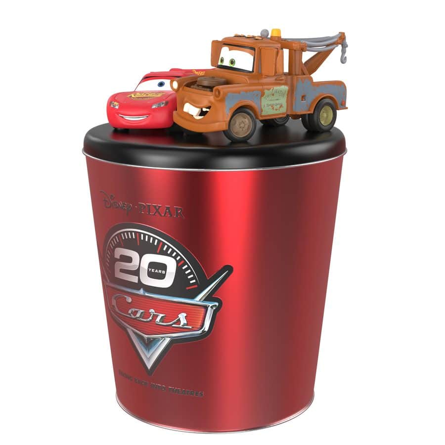 Mater and Lightning McQueen toy cars perched on a red Disney Pixar Cars cup