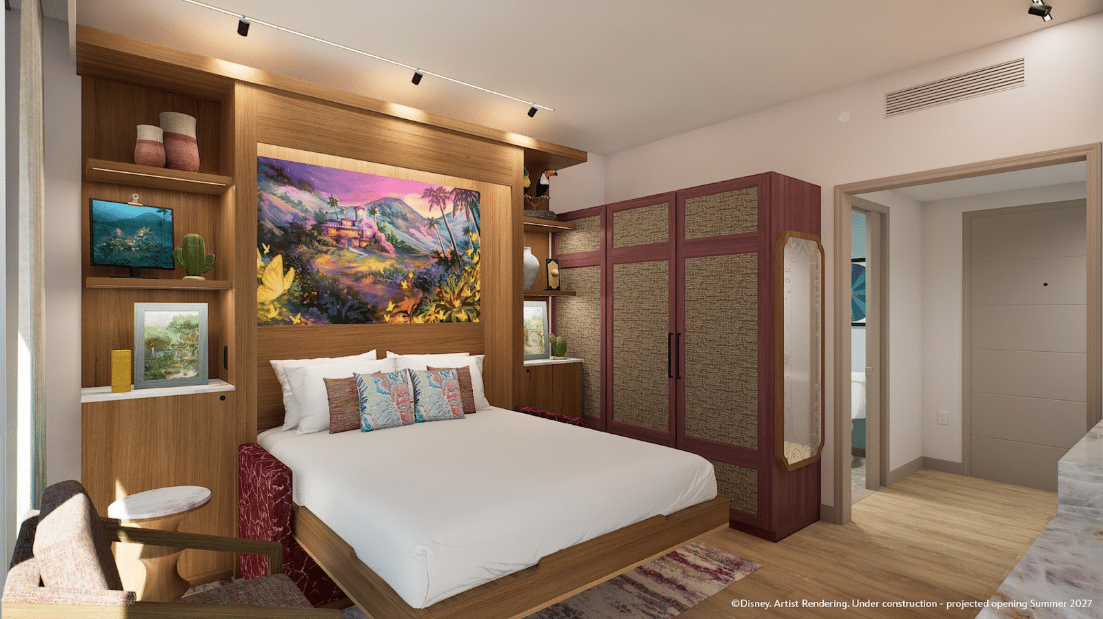 Hotel bedroom with a king bed tropical mural behind the headboard and built in wooden shelving