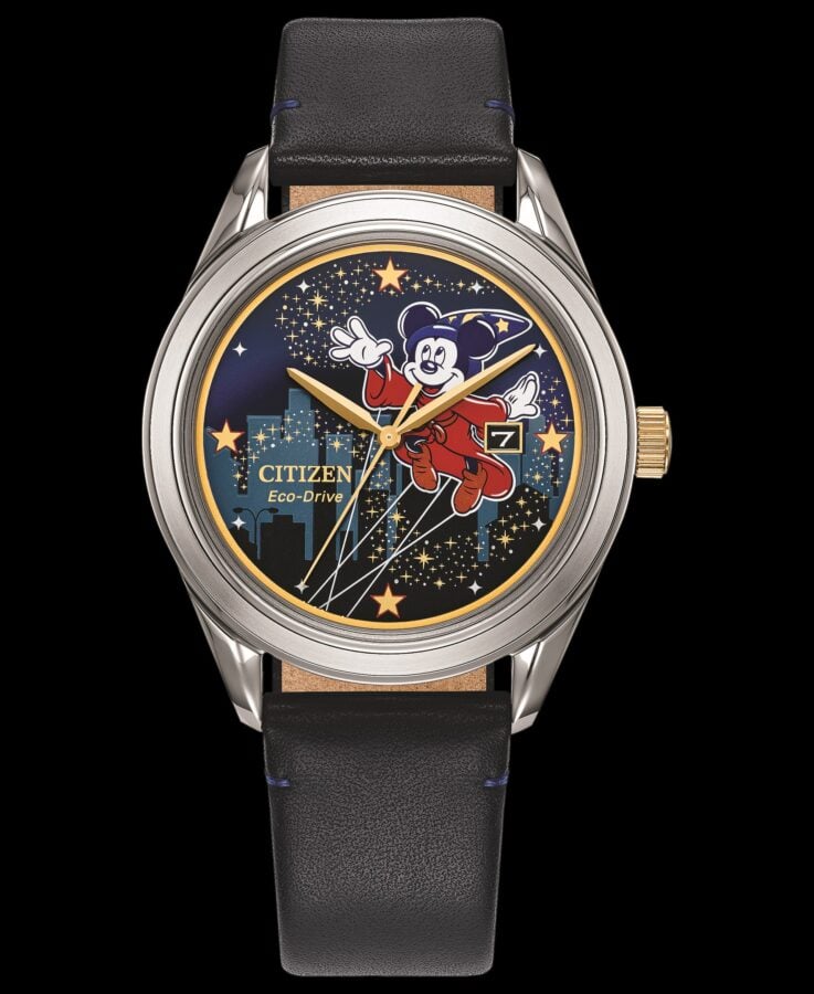 Citizen Eco Drive watch close up showing a Mickey Mouse illustration on a starry night dial gold hands and a black leather strap