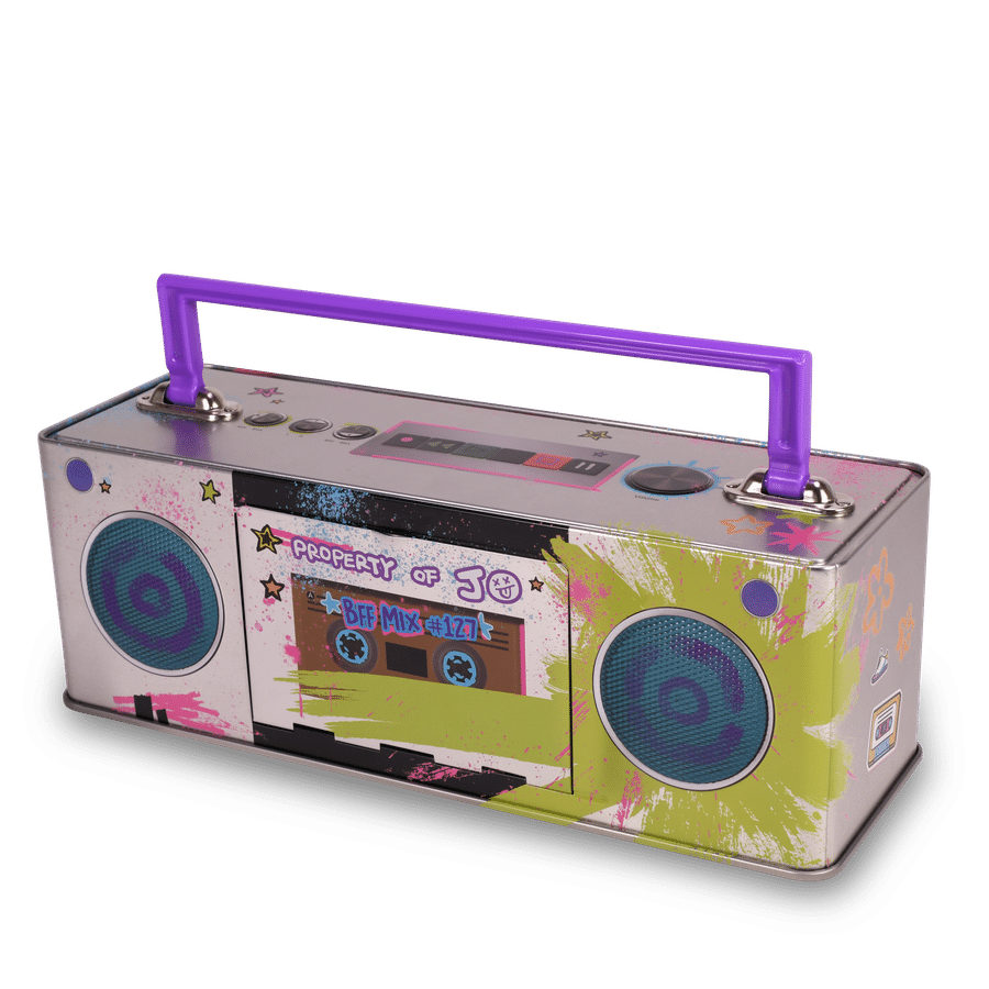 Colorful toy boombox with a purple top handle and graffiti paint splatters showing two large speaker grilles at the front