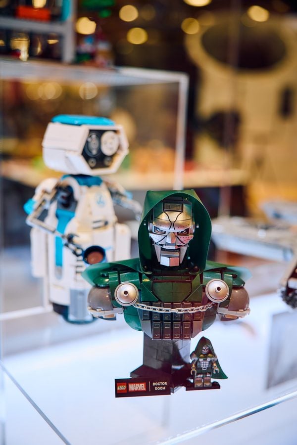 Lego Marvel Doctor Doom figure in a display case wearing a green hood and armor