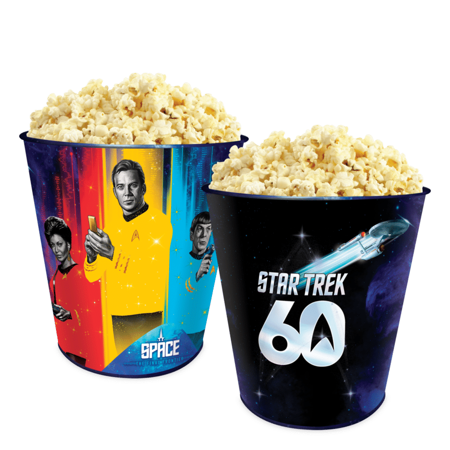 Two overflowing popcorn buckets with Star Trek space art against a black background overflowing with popcorn in the foreground and to the right