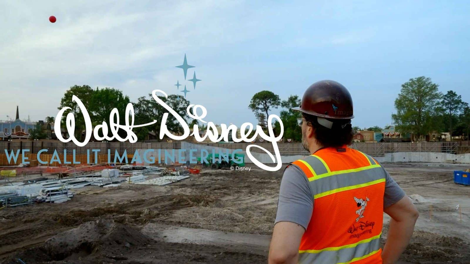 Construction site with a worker in a bright safety vest surveying the area overlay text reads Walt Disney We Call It Imagineering