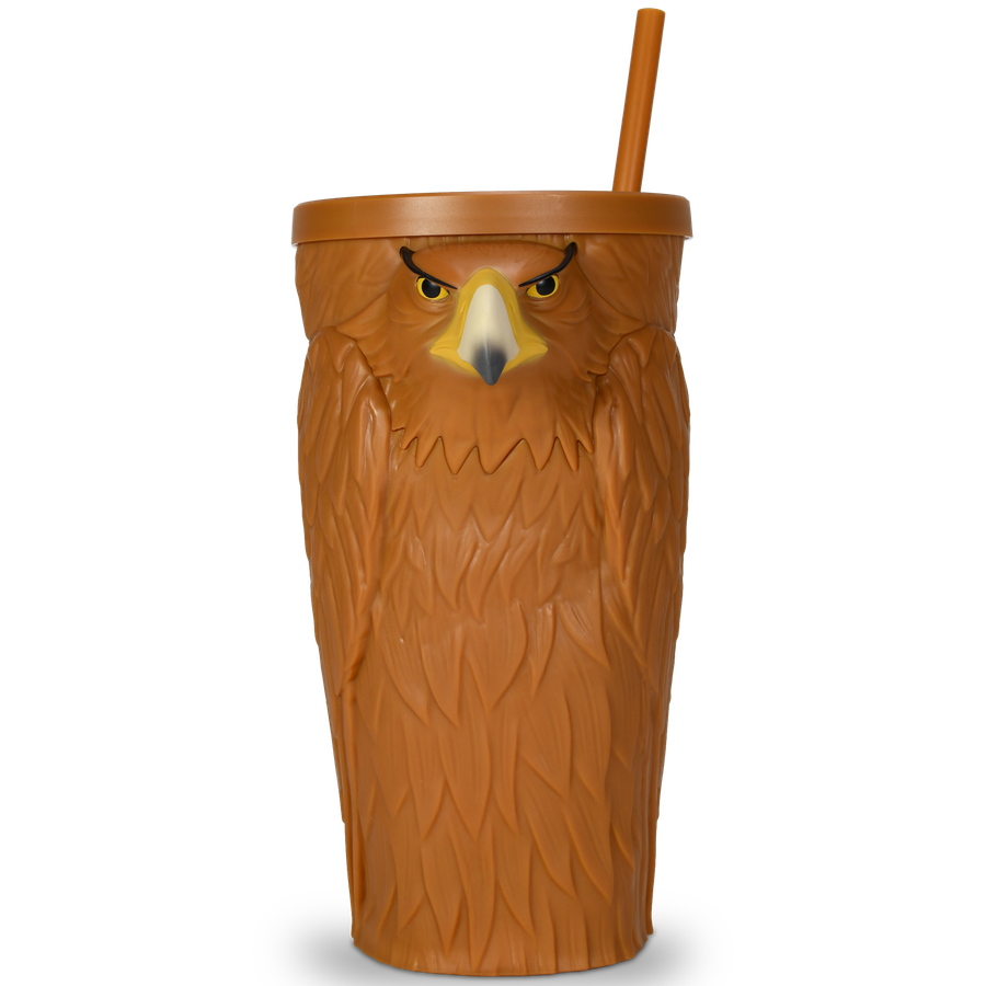 Turkey shaped drinking cup with a tall orange straw and a carved brown body featuring a yellow beak and eyes on the front facing forward