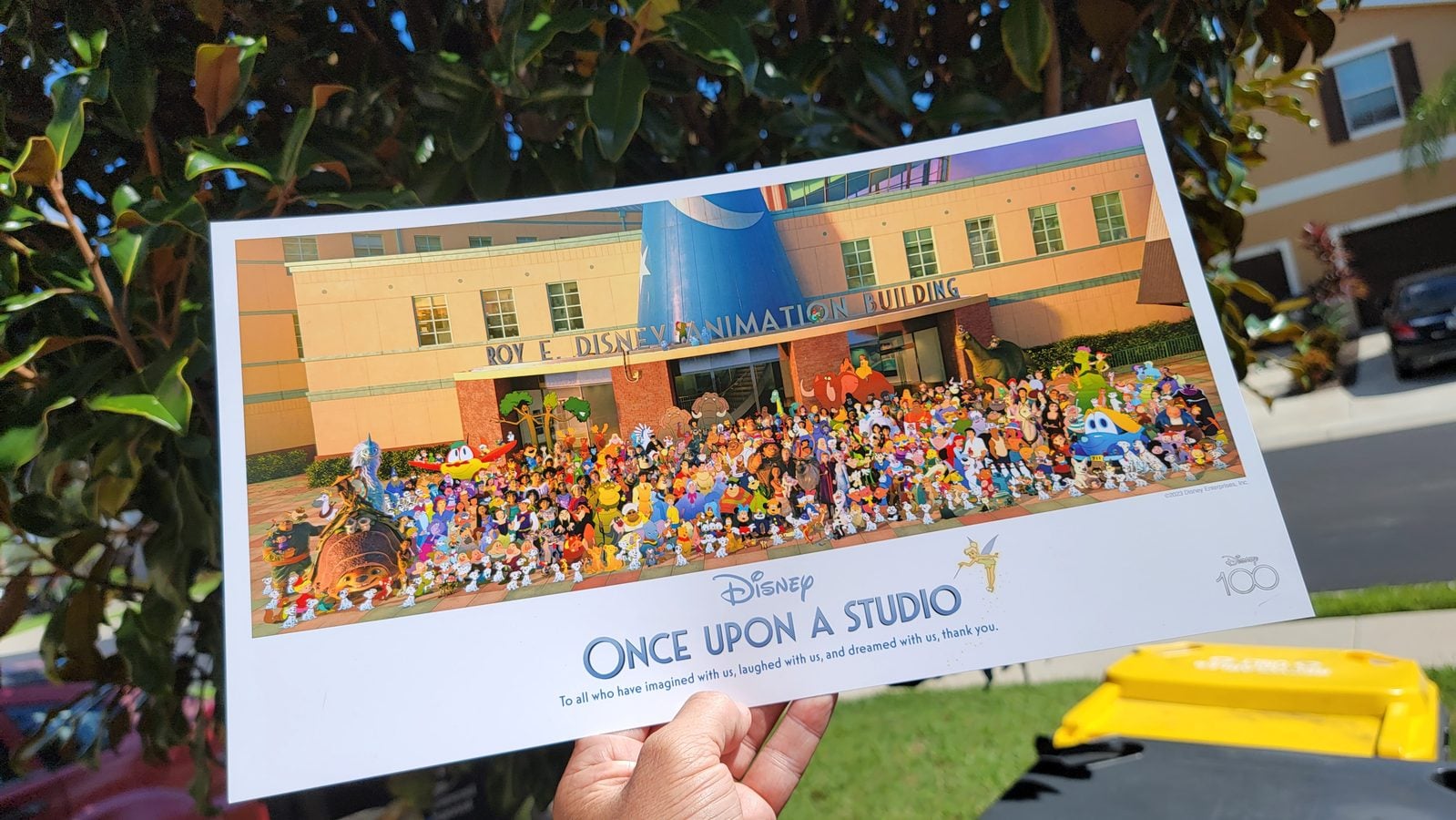Poster of Disney animation building scene held outdoors featuring a large collage of characters and Once Upon a Studio