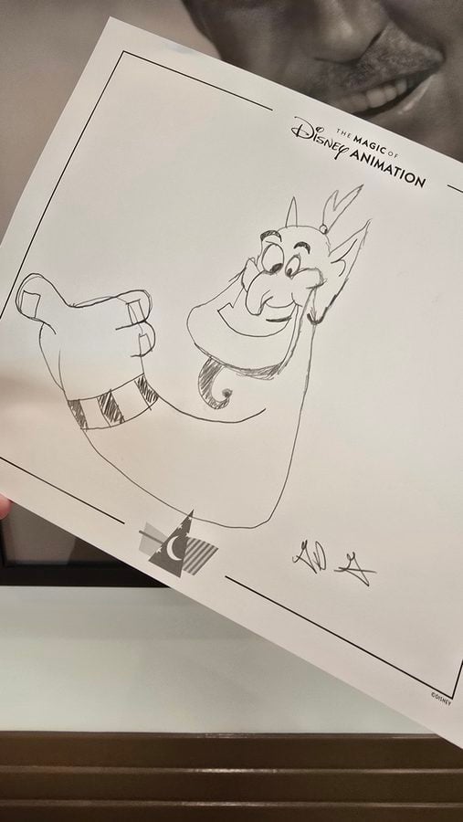 Hand drawn cartoon character giving a thumbs up on a Disney Animation sketch sheet labeled The Magic of Disney Animation