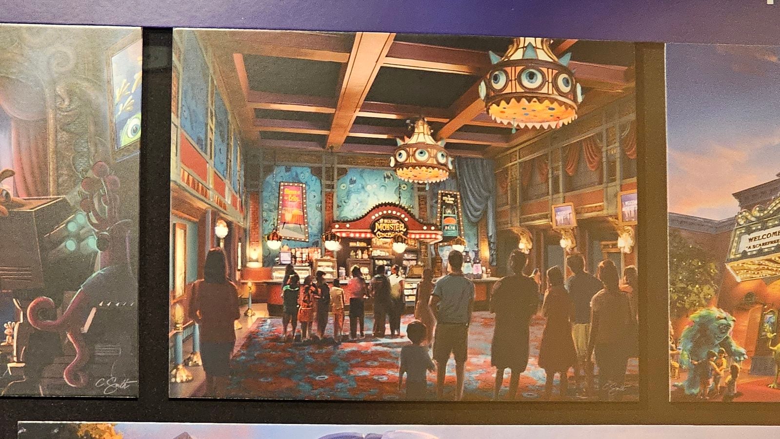 Indoor entertainment venue with whimsical monster themed décor hanging lanterns and a crowd of people in line near a ticket counter