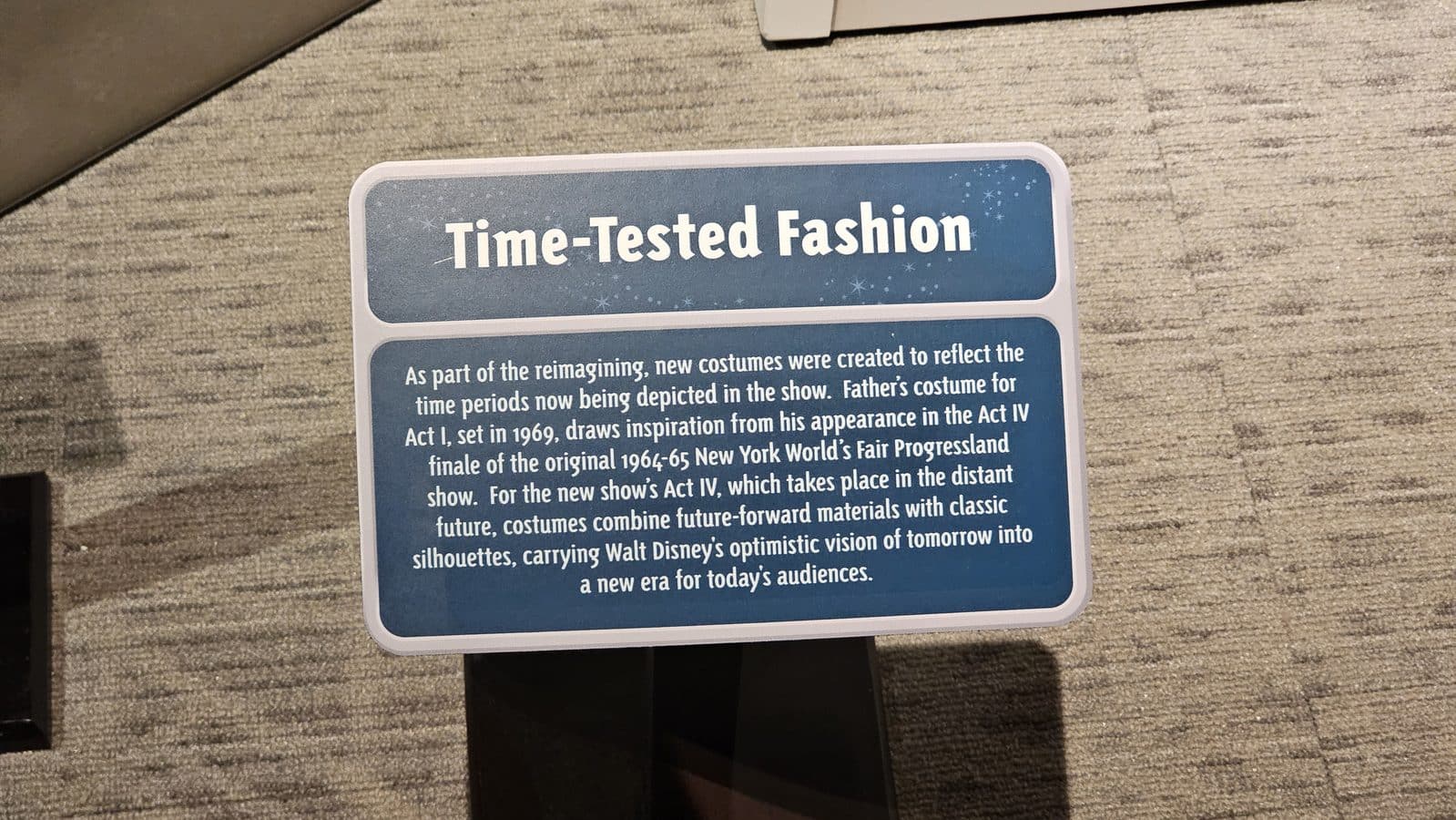 Blue information card titled Time Tested Fashion with text about reimagined costumes for a show