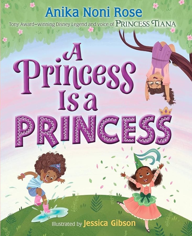 Cover of a childrens book titled A Princess Is a Princess with three happy girls dancing on a grassy hill pastel sky and large purple title text author Anika Noni Rose and illustrator Jessica Gibson credited