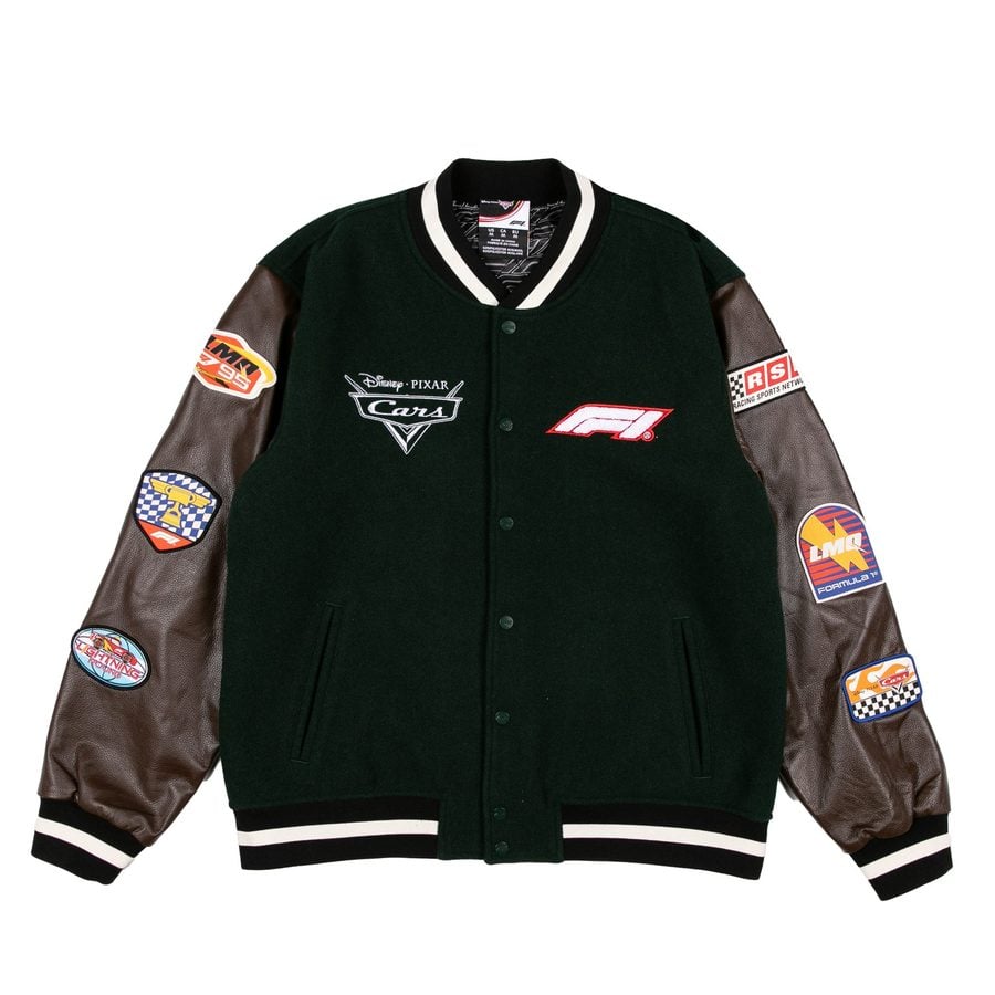Dark green varsity jacket with brown leather sleeves and racing patches on the sleeves and chest area