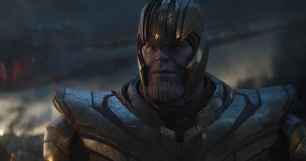 Close up of Thanos in metallic armor on a smoky war torn battlefield