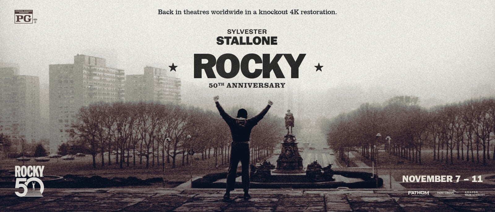 Movie poster for Rocky 50th anniversary showing a man with arms raised in front of a statue in a city park with retro grayscale styling