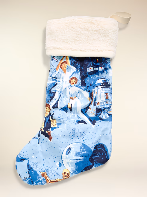cn63779058 Fantasy Land News Star Warsthemed Christmas stocking with a white faux fur cuff and blue space imagery hanging on a light background