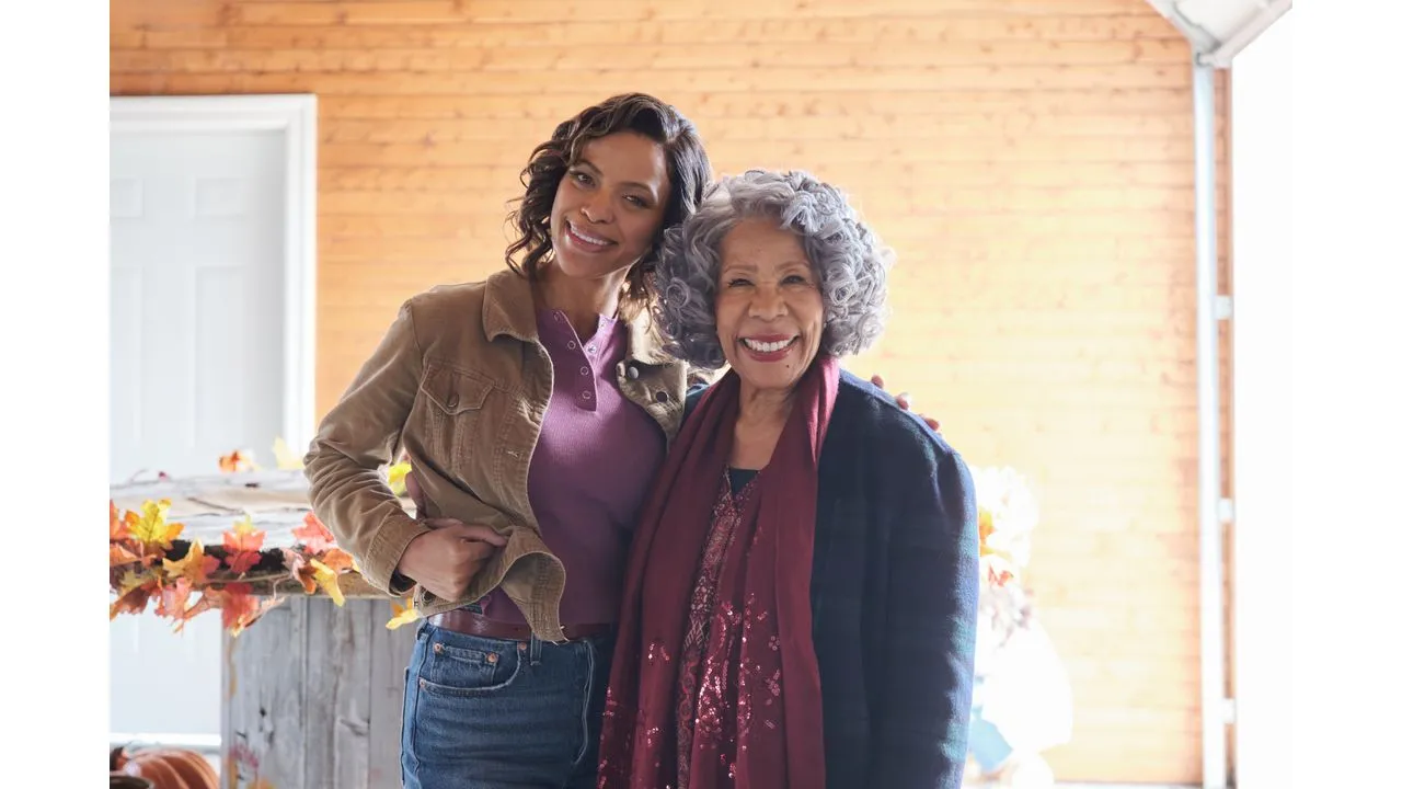 fallplace3 Fantasy Land News Two women a younger and an older woman smile and pose together indoors with autumn leaves decor in the background
