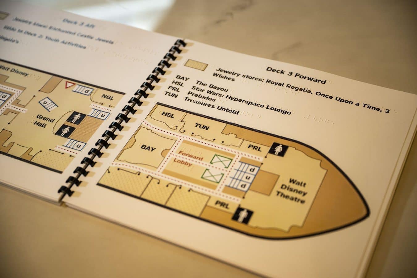 Spiral bound ship deck plan labeled Deck 3 Forward showing lounges corridors and the Walt Disney Theatre area with Forward Lobby nearby