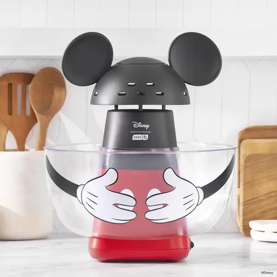 Disney themed blender with Mickey Mouse ears on top red base set on a kitchen counter