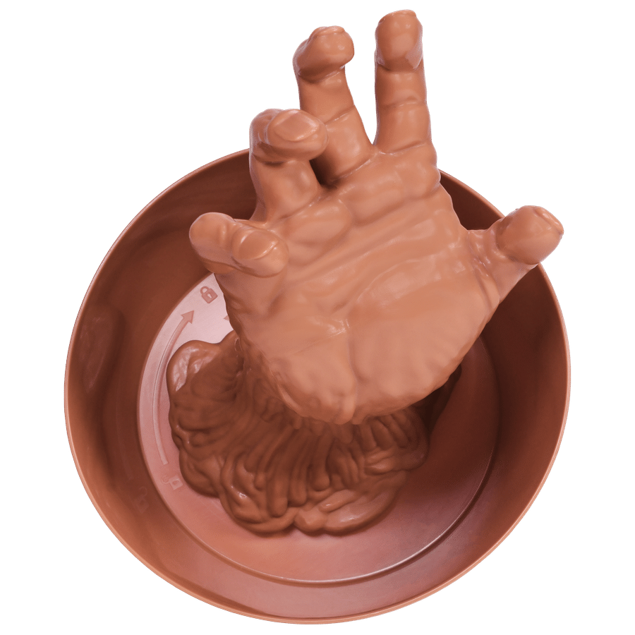 Life like silicone hand partially submerged in a brown bowl emerging from the rim