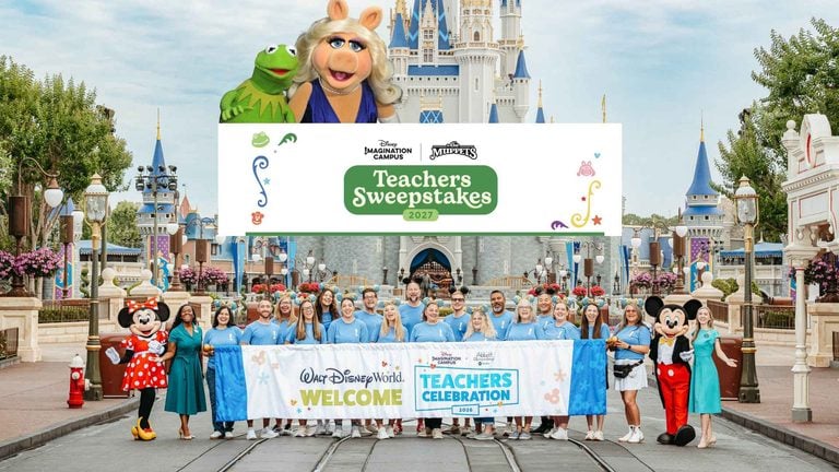 Group of teachers in matching blue shirts posing with Mickey and Minnie at Walt Disney World, under a 'Teachers Celebration' banner.
