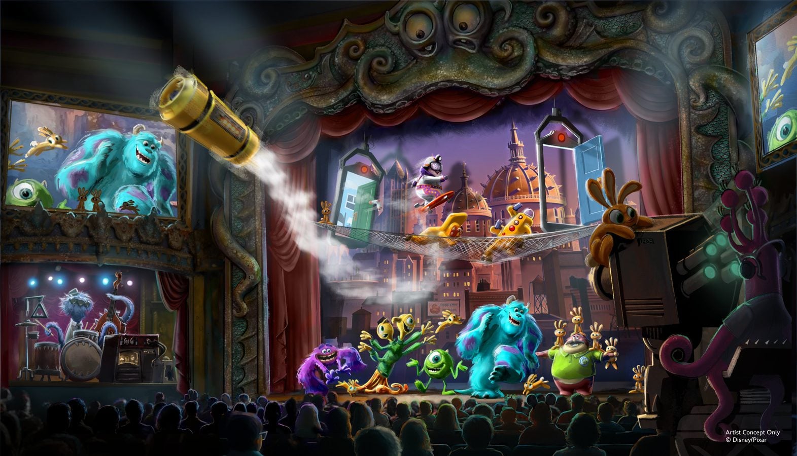 Colorful stage show with blue and green monsters performing on a theater set audience seated in the foreground